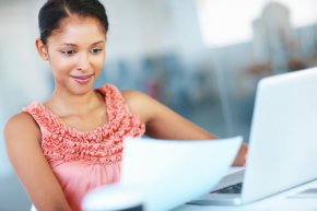 A young office worker doing some work on her laptop